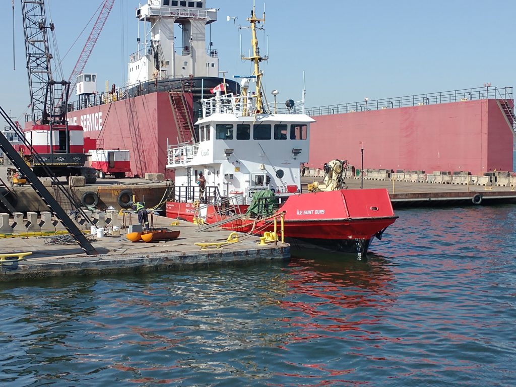 A Canadian Coast Guard vessel is tied to a dock