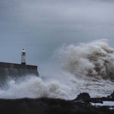 Wave crashing near lighthouse at Porthcawl, UK