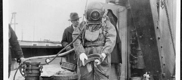 Diver holding a water main joint, 1924. Courtesy of the Seattle Municipal Archive. Image ID 6119