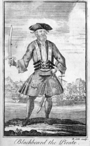 A well dressed man stands in the centre of a woodcut printed image, with a sword in his right hand and his left hand on his hip